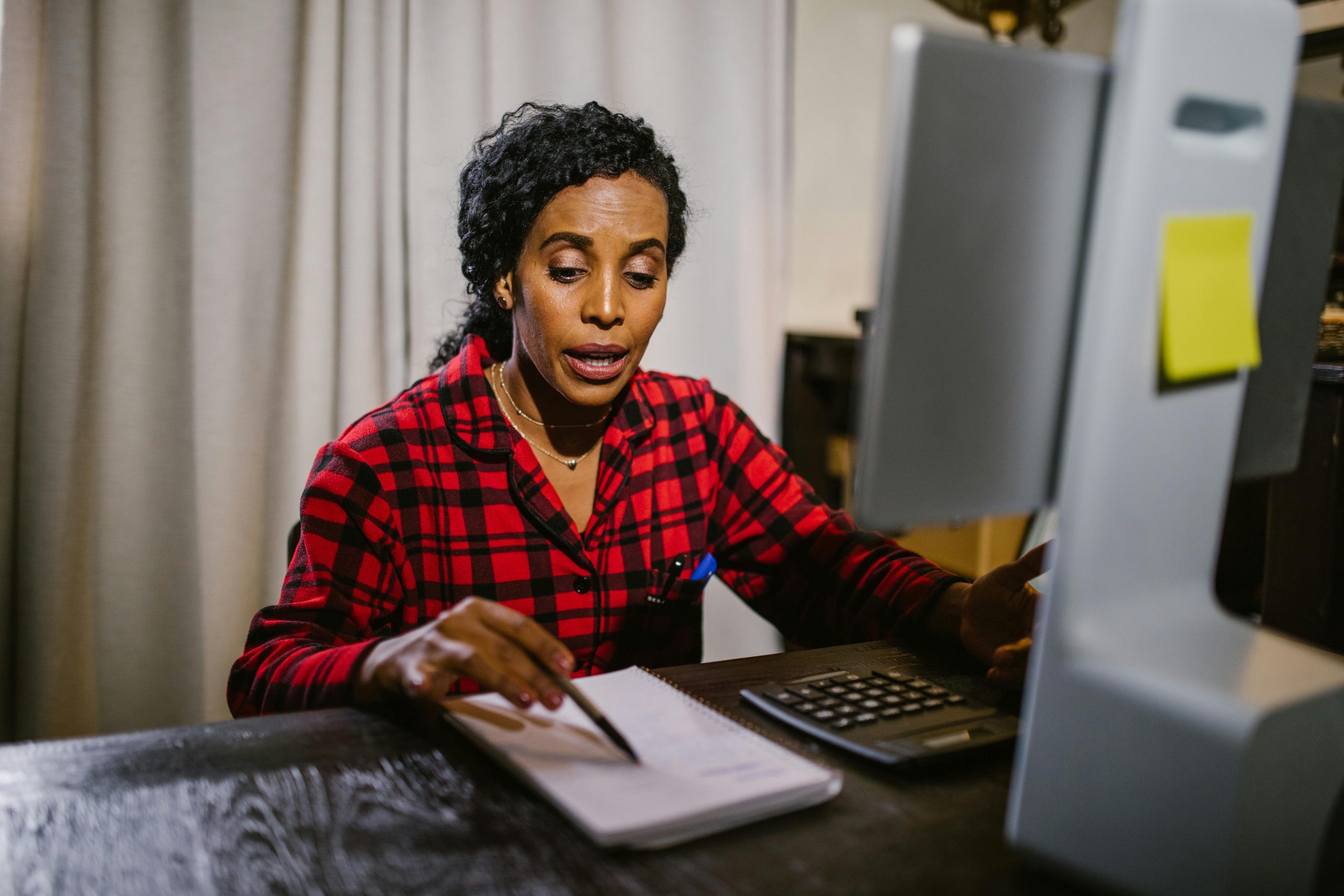 Woman sits before a screen preparing for a remote interview